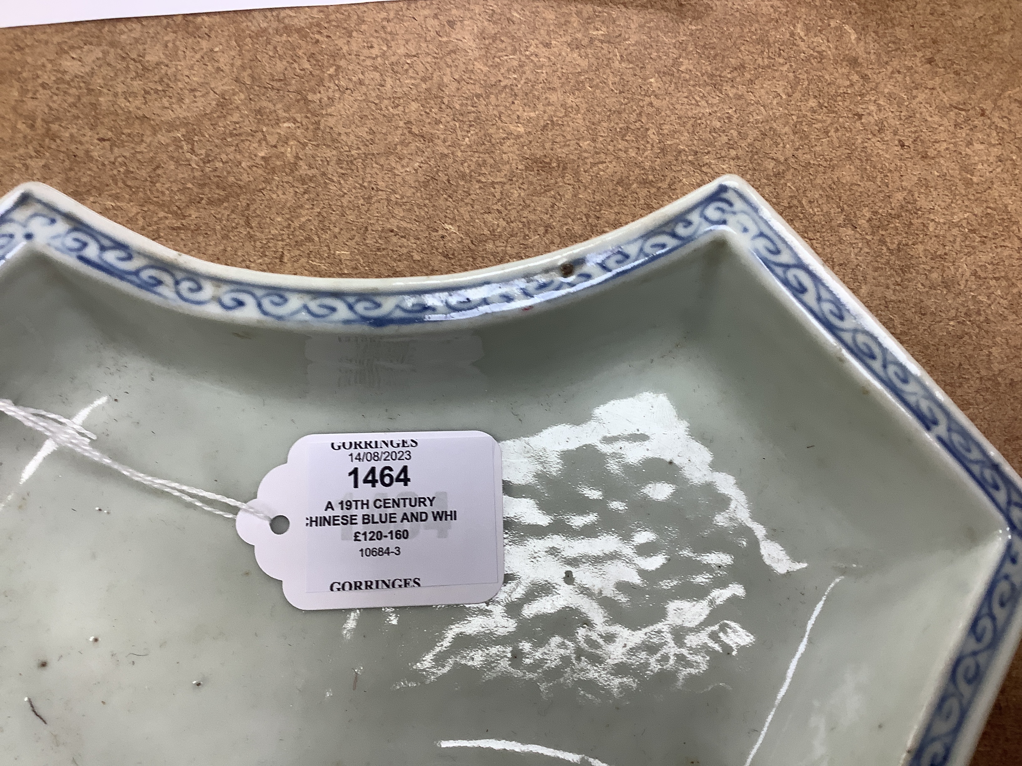 A 19th century Chinese blue and white ingot shaped dish and a famille rose footed dish, the largest 25cm wide (2)
